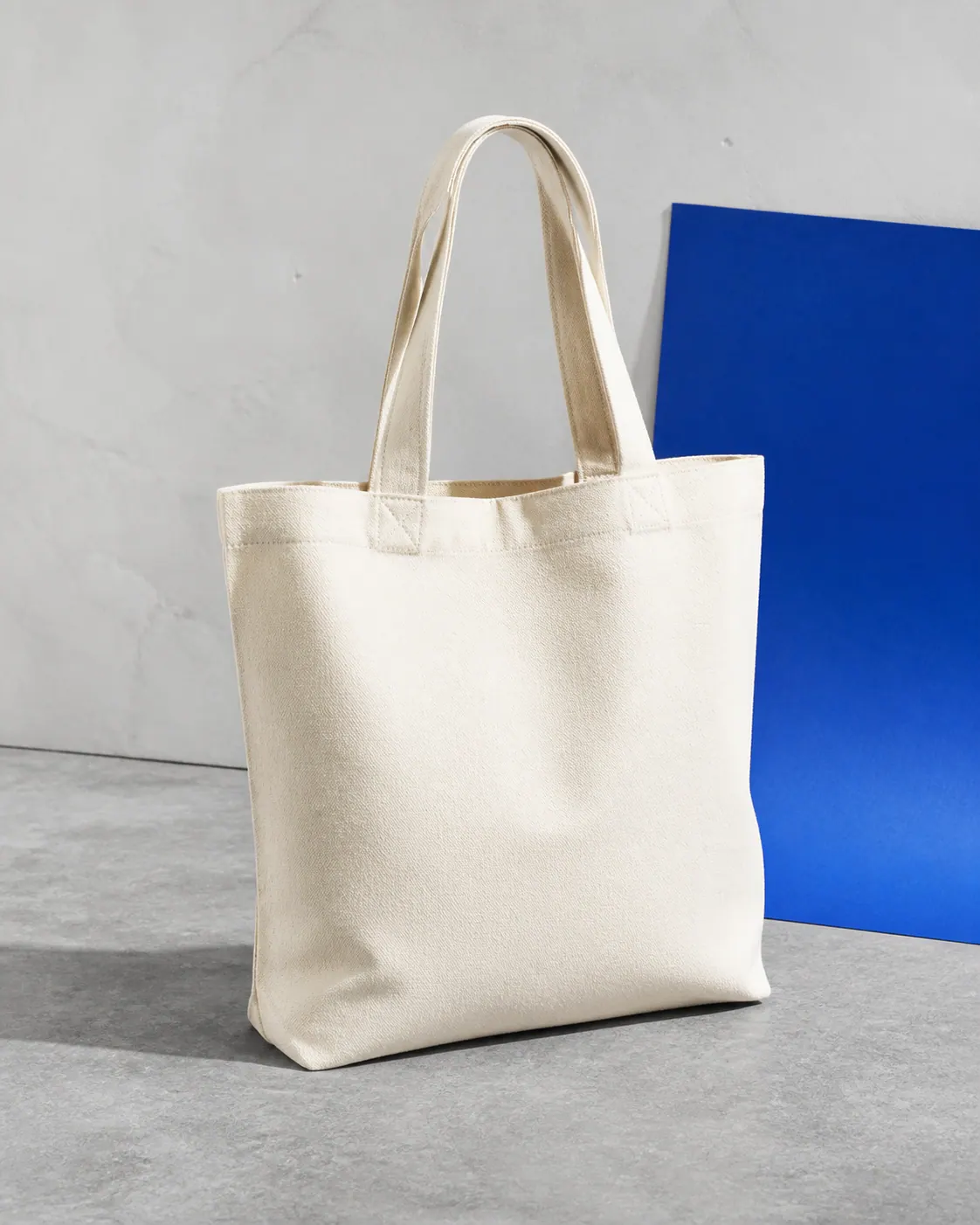 Blank natural canvas tote bag with reinforced handles ready for custom printing